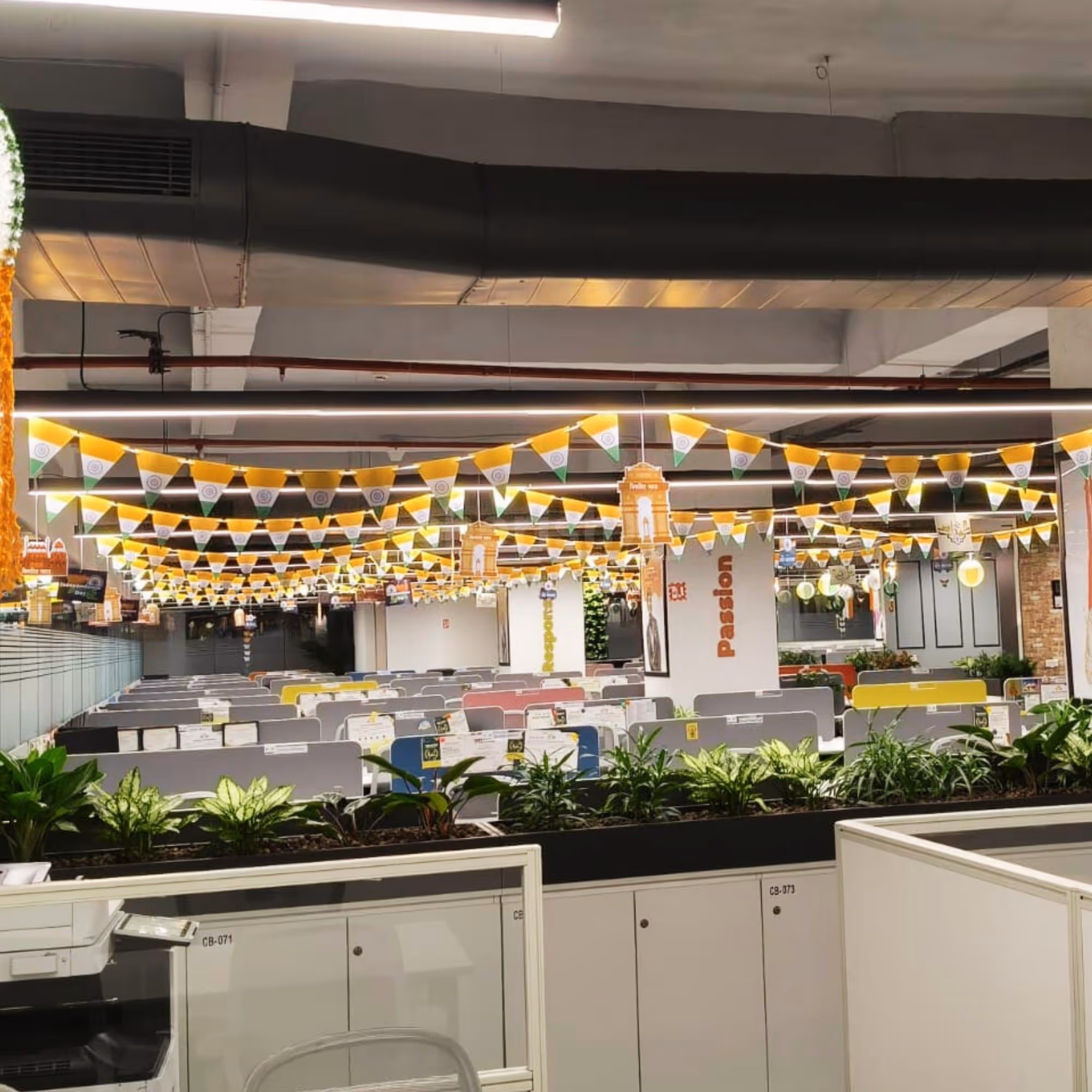 Paper danglers shaped as an Indian Flag spin spirally while the bunting swings in the air.