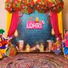 Yellow and pink fabrics are eye-catching hues around the Lohri banner on the stand.