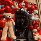 A sweet teddy bear stands at the entrance, welcoming guests with a touch of playful romance.