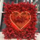 Heart-shaped photo booth, surrounded by Valentine props perfect for couple photos
