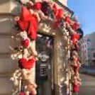 A charming Valentine's entrance decorated with red bows, cuddly teddy bears and soft artificial flowers, welcoming guests warmly.