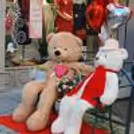 Festive Valentine's entryway designed with a large heart frame, red drapes and floral touches, setting a loving mood from the first step.