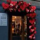 A heart-themed photo booth with elegant frame, red curtains, Valentine props and soft lighting perfect for Instagram ready candid couple photos.