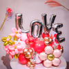 Love silver foil balloons shout heartfelt emotions in a shimmering arch.