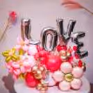 Love silver foil balloons shout heartfelt emotions in a shimmering arch.