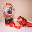 Soft baby breath bunches in the bucket against the bubble balloon are heart-warming