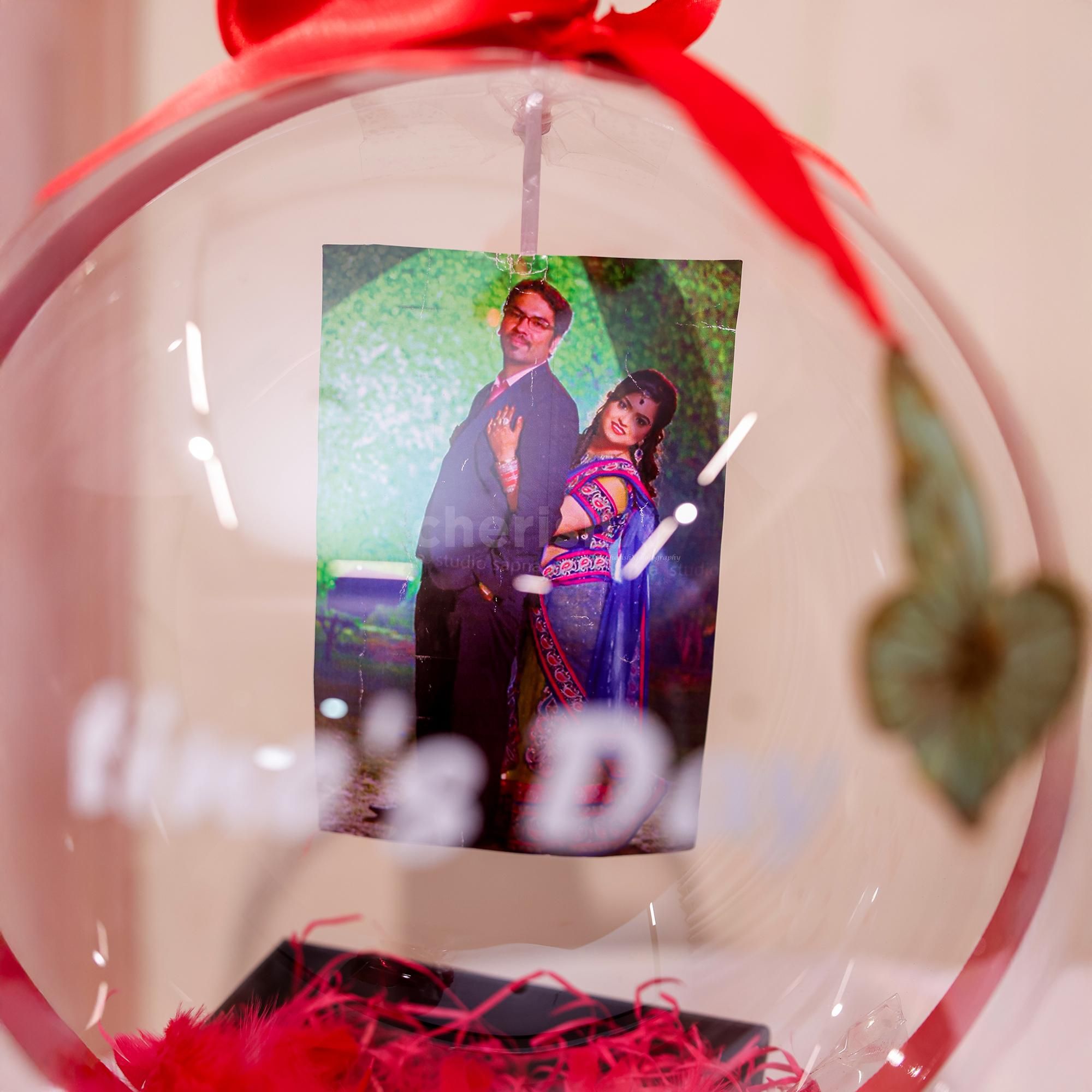 The red bow on the top of the bucket gift wraps it perfectly, inviting an affectionate touch.