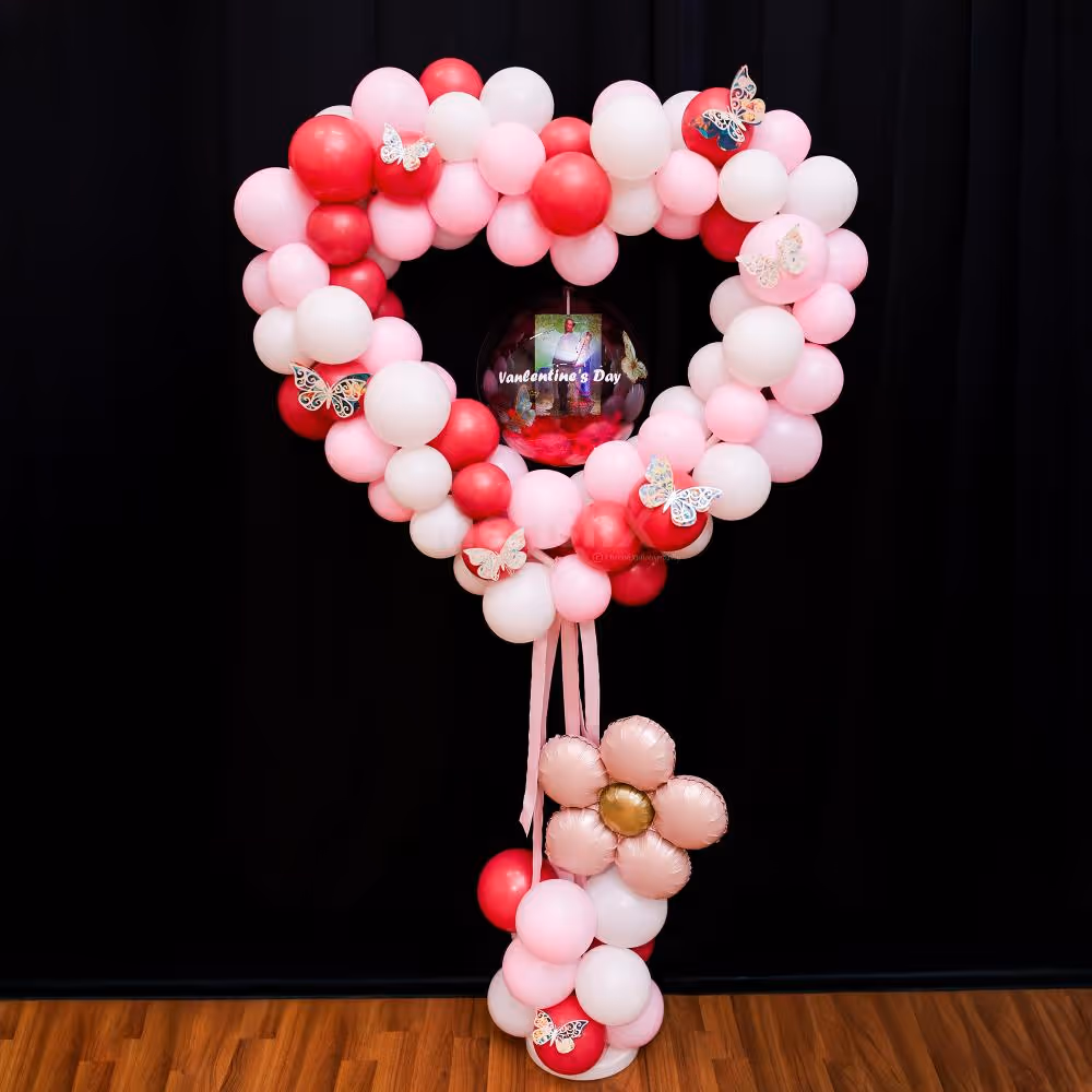A bubble balloon with red feathers and a couple of pictures makes the bouquet customized.