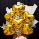 A golden ribbon flower bow adds royal look to the foil balloon bouquet.