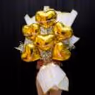 Baby breath bunches highlight contrast against golden heart-shaped balloons.