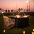 Candlelit dining table with petals on an outdoor terrace at Ramada Encore
