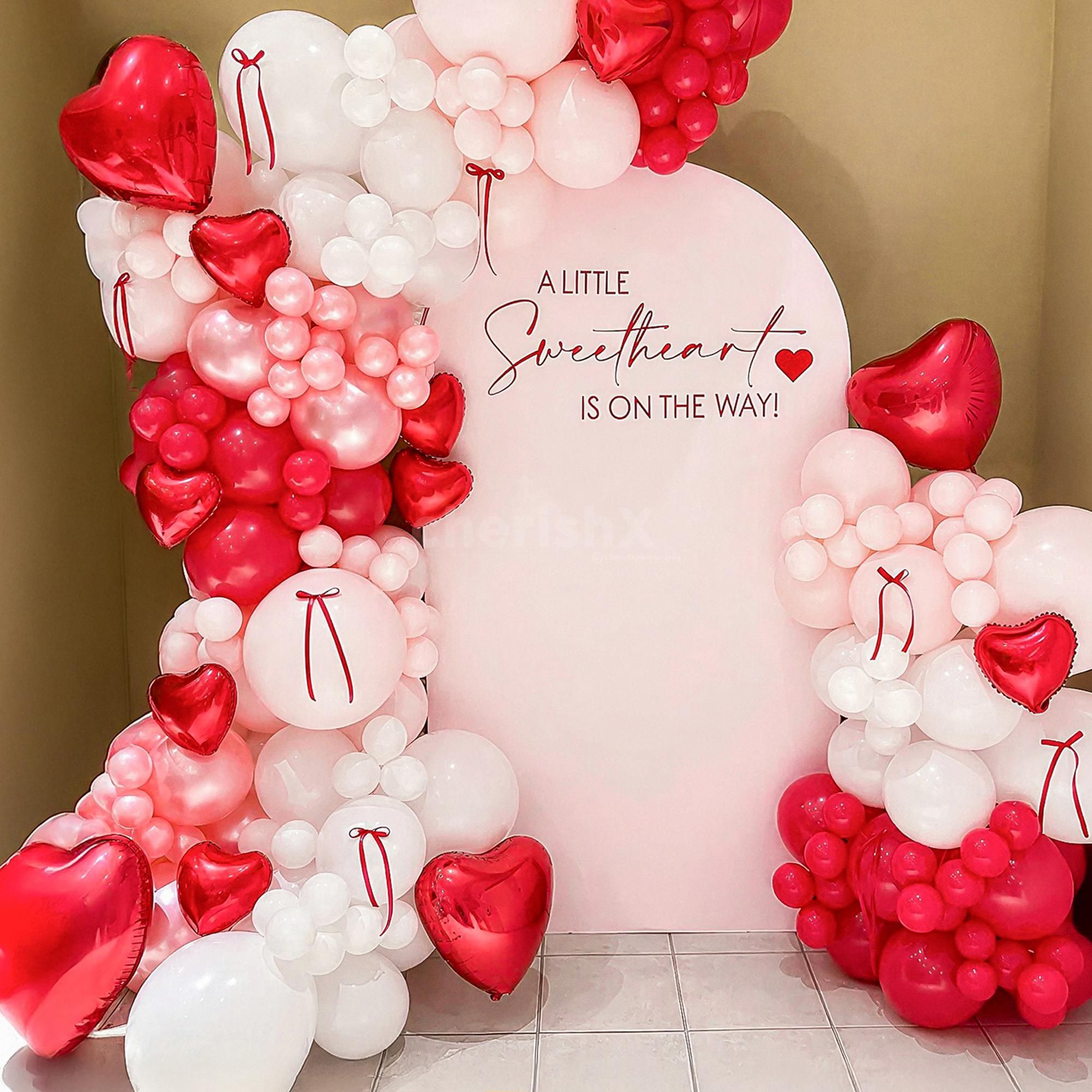 The decor looks more beautiful with macron balloons and red ribbon bows.