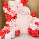 The decor looks more beautiful with macron balloons and red ribbon bows.