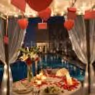 Couple dining at open-air cabana by the rooftop pool