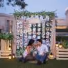 Bunch of artificial leaves in the carats and on stand adds greenery to the backdrop