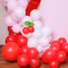 Macron and latex balloons together form a grand arch in vibrant tones and texture.