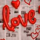 The cursive Love foil balloon on the flex highlights that Cupid is back