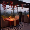 Elegant table décor with LED candles and rose petals under the open sky