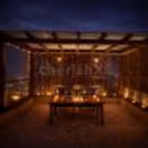 Romantic poolside gazebo candlelight dinner table with Rose Petals and an elegant dining arrangement.