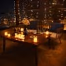 Luxury poolside gazebo restaurant with private candlelight dinner setup to host a proposal and anniversary celebration.