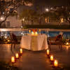 Romantic open-air dining with LED candles and rose petals