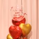 Red ribbon bows add cute finishing touches to the bubble balloon design