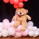 Teddy bear and monochromatic shades of pink balloons