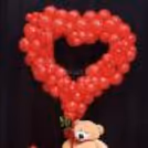 Red latex balloons create a classic and romantic celebration theme