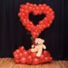 A single artificial red rose adds classic romance to the bouquet
