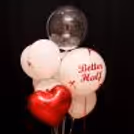 A red ribbon foil balloon adds contrast to the white theme