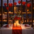 A beautifully decorated outdoor table overlooking the pool for a romantic Valentine evening
