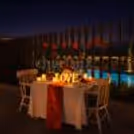 Pool-view candlelight setup paired with wine, music, and Valentine charm