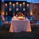 Intimate evening dining with shimmering pool reflections