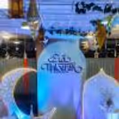 Multiple sunboard cutouts, decorated with strip lights, form a captivating backdrop.