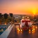 Romantic dining by the pool with roses, candlelight, and love in the air