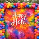 The mixed color balloon arch around the banner makes a playful Holi decor