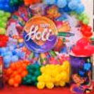 The mixed colour balloon arch around the flex banner is an ideal border that enhances the banner's grace.