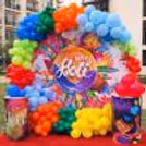A ring stand with a 6 x 6 flex banner makes a perfect backdrop for a Holi celebration.