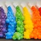 Six colourful balloon buckets, overflowing in the background against the wall, add a splash of colour to the venue.