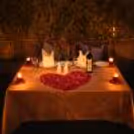 Romantic setting with rose petals creating an intimate atmosphere at your private table