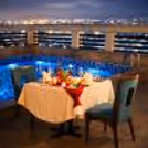 Experience elegance with a beautifully decorated table by the serene pool.