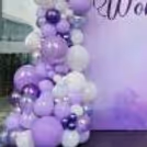 Chrome Silver balloons add dramatic glitter in the arch that empowers Feminism