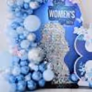Chrome macron balloons in blue and silver colours add texture to the decor