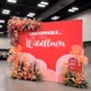 A vibrant Women's Day backdrop adds a powerful and celebratory touch to the event.