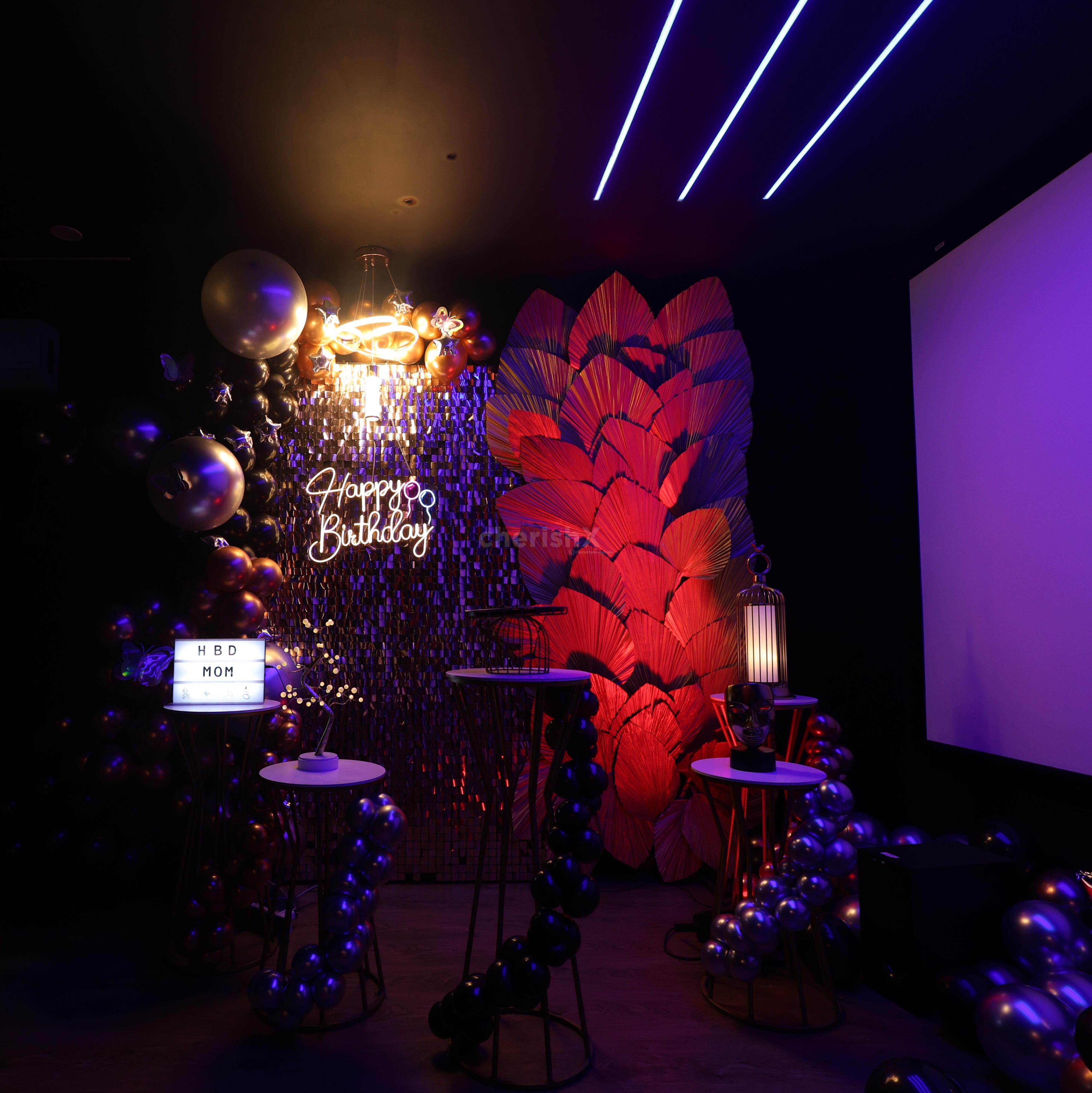 Birthday movie night with neon lights and stylish party décor.