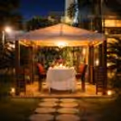 An intimate cabana candlelight dining setup at Hilton Baani Square, perfect for a magical evening under the stars.
