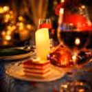 A beautifully decorated private cabana table paired with fine dining and warm lights for the perfect romantic date night.
