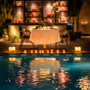 An intimate poolside candlelight dining setup at Expo, Greater Noida, where warm lights, calm waters, and a beautifully decorated table create the perfect romantic evening.