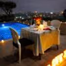 An intimate rooftop poolside candlelight dining experience at Radisson Paschim Vihar, Delhi perfect for romantic celebrations.
