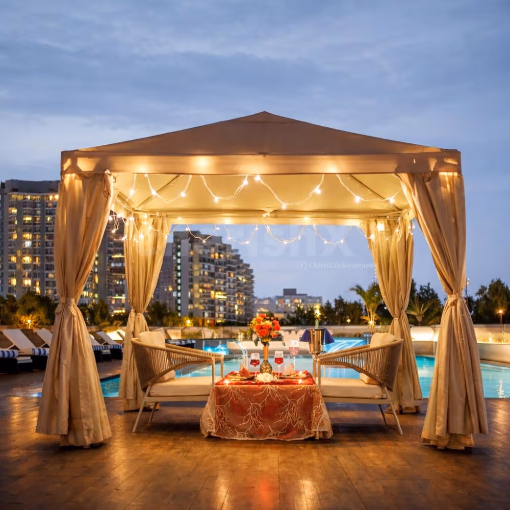 An intimate poolside cabana setup at Hilton Baani Square, designed for an unforgettable romantic evening under soft lights and city views.